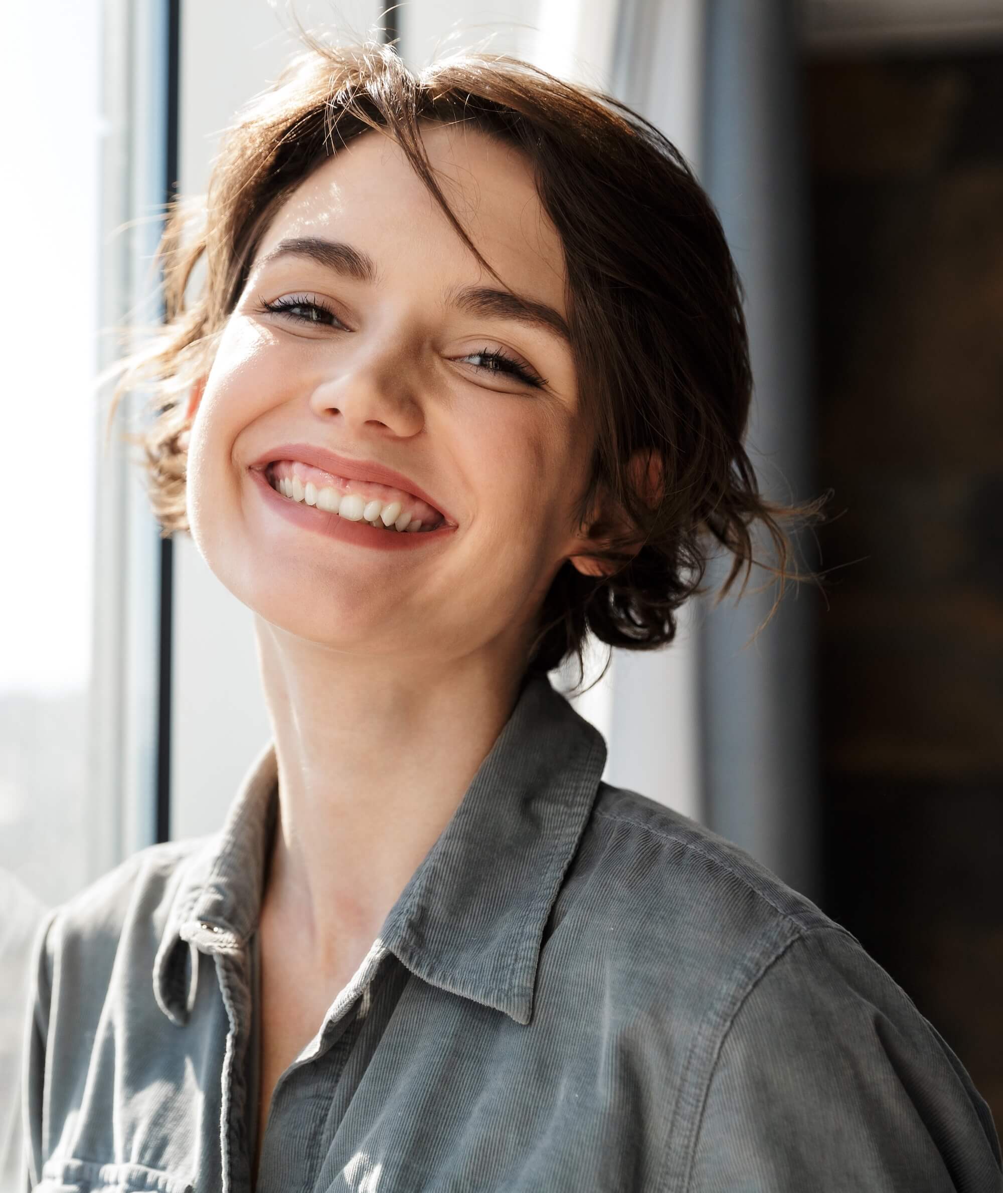 Photo of a brunette woman with short hair smiling