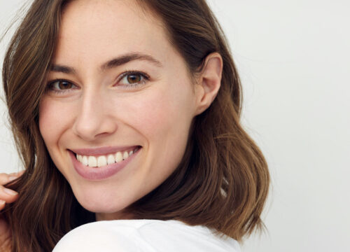 Photo of a smiling brunette woman with great skin