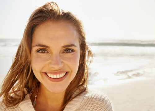 Photo of a woman with great skin at the beach after Fotona Laser Therapy